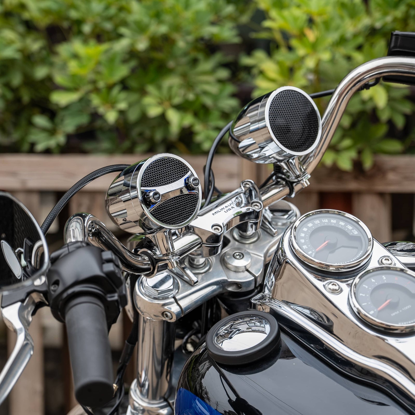 Premium chrome KSPEAKER motorcycle handlebar speakers perfectly matching the shiny dashboard and riser of a classic cruiser motorcycle.