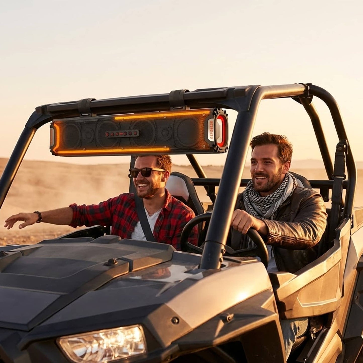 Two riders enjoying a KSPEAKER K66 sound bar mounted on a UTV at sunset