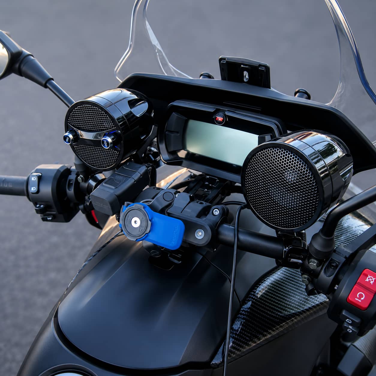 Premium black KSPEAKER handlebar audio system mounted on a trike, blending seamlessly with the modern dark dashboard and windshield.