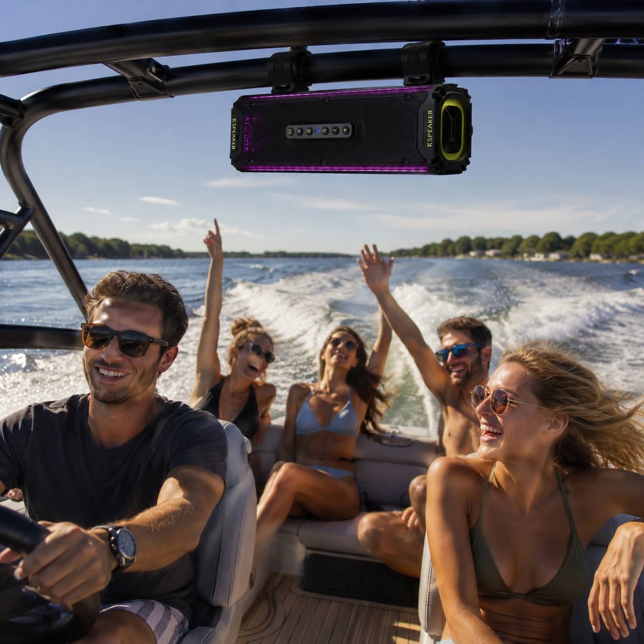 Marketing photo of friends laughing on a speedboat, with a waterproof marine soundbar mounted on the wakeboard tower. Highlighting the ultimate party audio system for summer lake cruising and open-water boating.