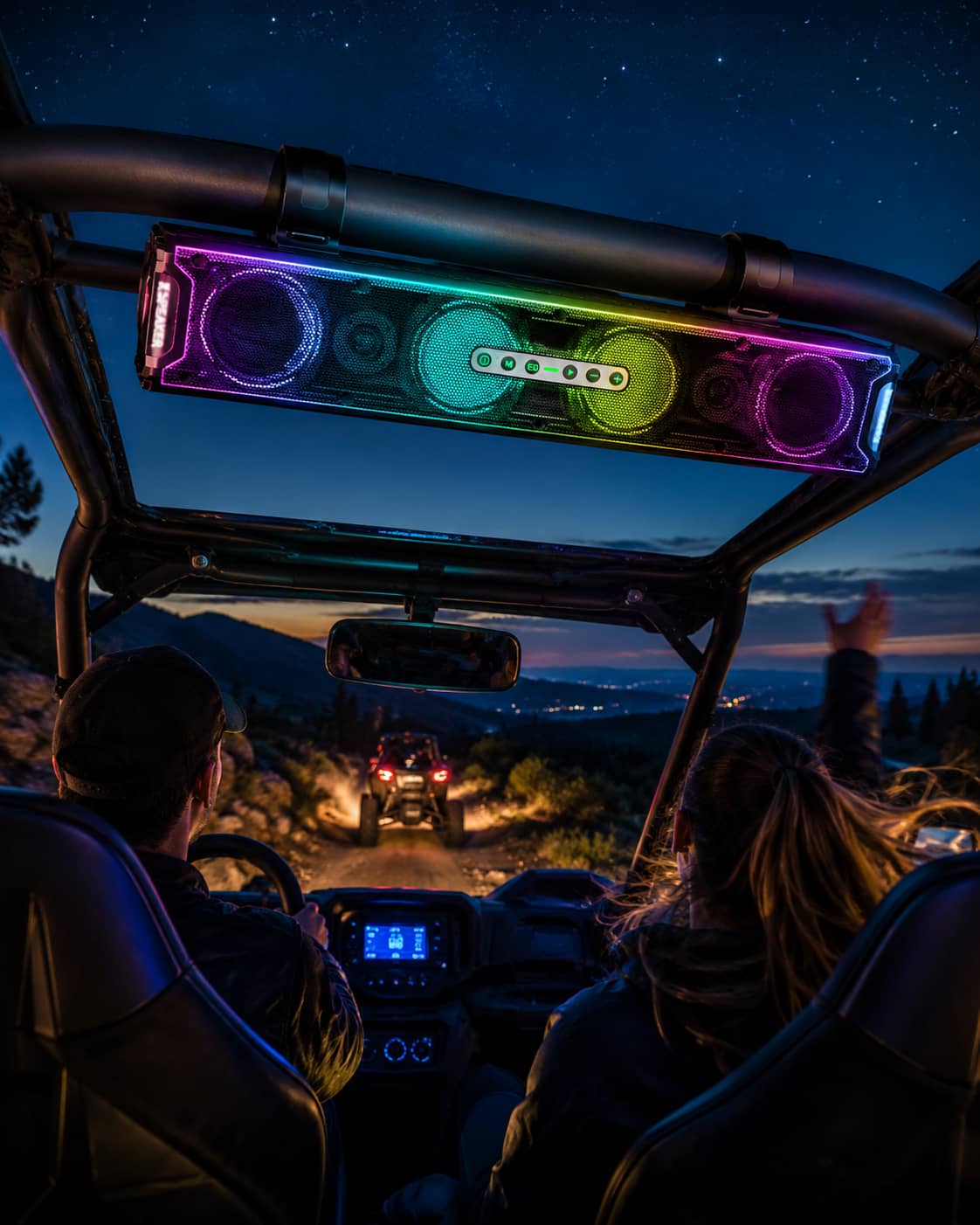 Marketing photo of a waterproof UTV soundbar with vibrant RGB lights driving under a starry night sky. Highlighting the dynamic multicolor illumination engineered for nighttime off-road trail riding.