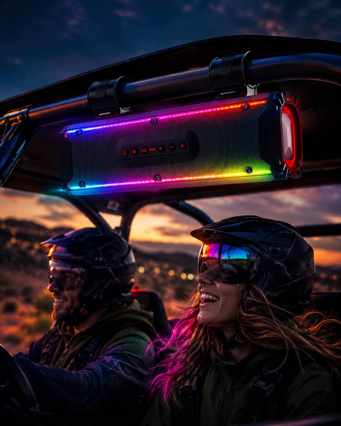 Marketing poster of two riders in an off-road UTV (SxS) at night, with the front soundbar glowing with customizable RGB lights and multicolor spectrum effects. Bright neon purple and yellow light beams radiate from the bar.